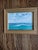 Offered is a pretty framed watercolor of an ocean view. The overall frame measures 9 by 7. It has a nice gold frame. I had...
