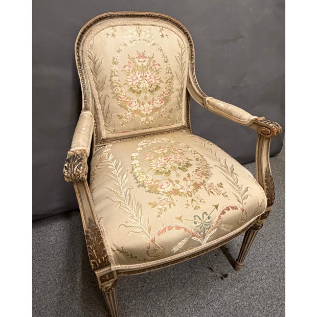 This set of four French Louis XVI style armchairs, circa 1890, features original polychrome and parcel gilt finishes with...