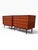 A matched pair of Danish modern four-drawer dressers in richly figured teak, by Arne Vodder. Full-width sculpted pulls are...