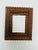 This is a vintage Tramp Art frame, a beautiful example of folk artistry that transforms humble materials into richly...