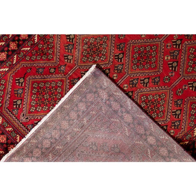 Beautiful hand-knotted wool, vintage, Persian Heriz rug. This rug has a stunning red field with an allover geometric...