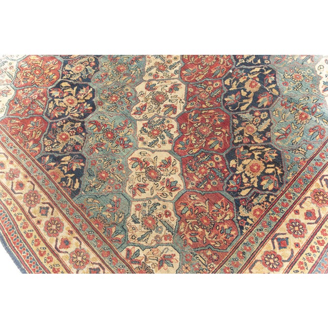 This circa-1880 antique Persian Kerman rug is a striking display of color and innovative design in bold red and contrasted...