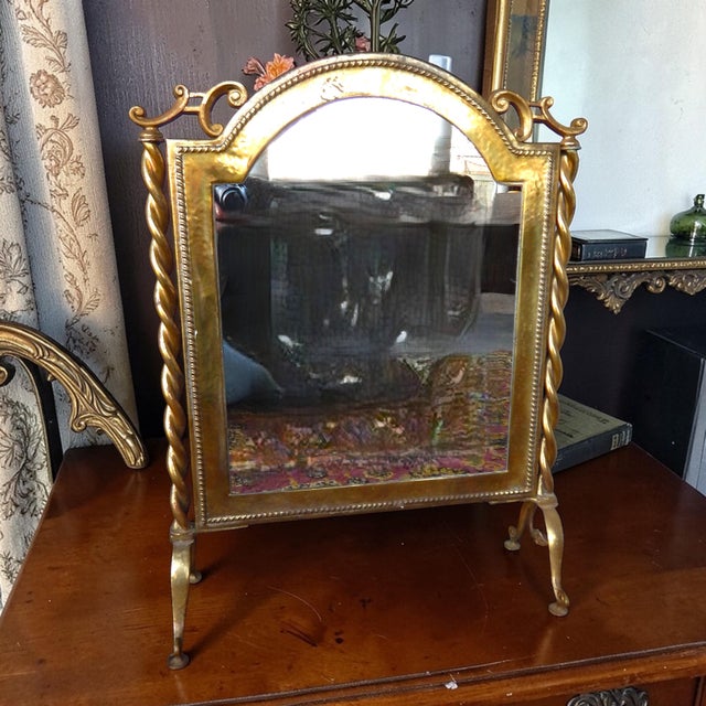 Elegant gilt metal mirror suitable for table top of on the floor to admire your new shoes. Very solid and well made....