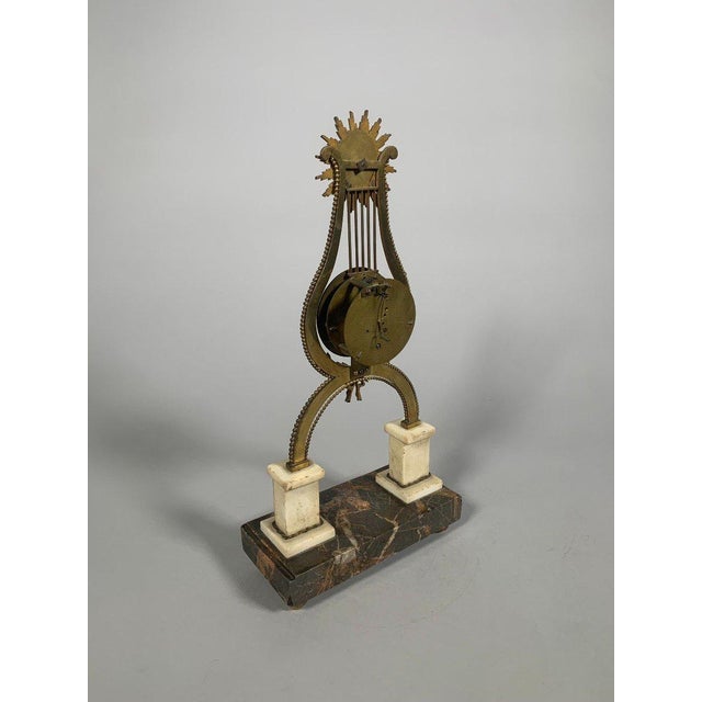 Louis XVI period skeleton clock. French work, circa 1760. Visible mechanism. The clock is in the form of a harp surmounted...