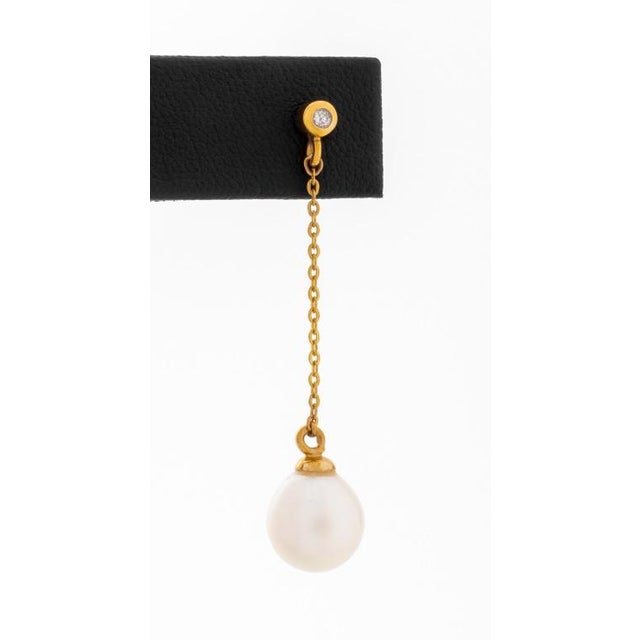 14K yellow gold, featuring 2 oval drop cultured pearls approx. 9.5 x 10.5 mm., further adorned with 2 round brilliant cut...