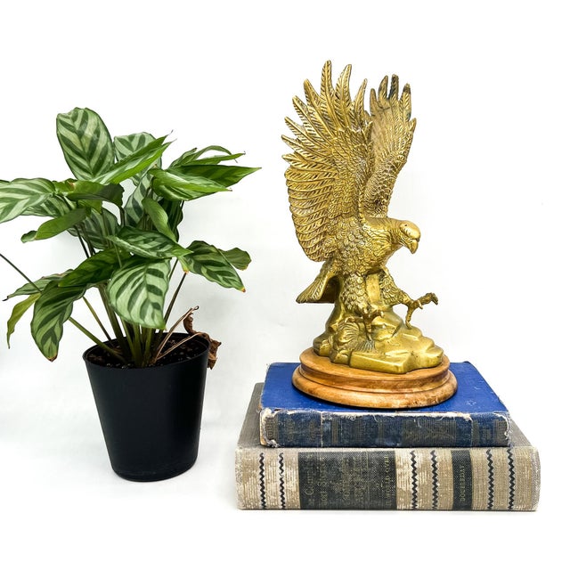 Striking vintage brass eagle sculpture with dramatic outstretched wings and finely detailed featherwork throughout,...