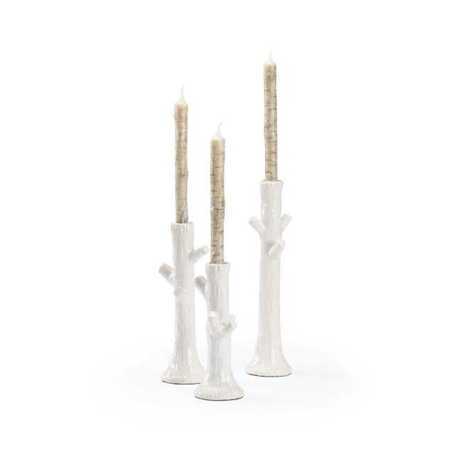 Branch out your design style with our Faux Bois candlesticks. This set of three white glazed ceramic candlesticks bring...