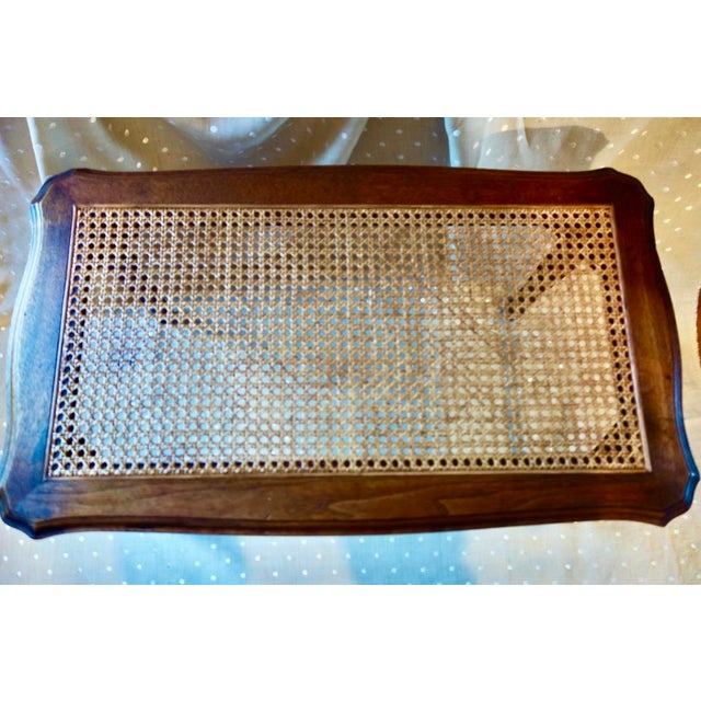 French style cane and walnut rectangular bench with cabriole legs and graceful curves on long sides. The cane inset is...