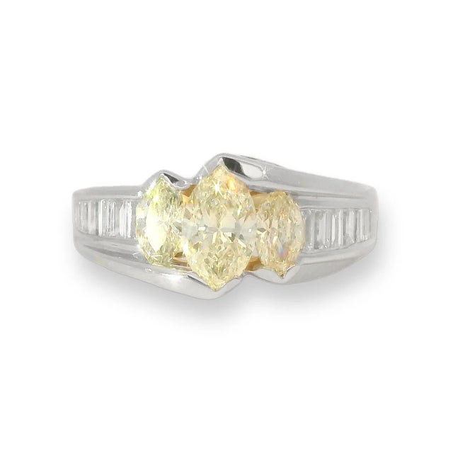 This rare estate ring is beautifully handcrafted in 14K white gold and features a striking combination of yellow marquise...