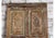 This striking antique carved wood door features a beautifully aged distressed green finish, revealing layers of history...