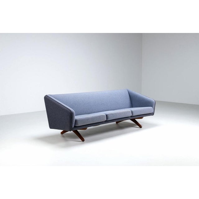 A refined Illum Wikkelsø model ML-90 three-seater sofa, produced by Mikael Laursen, Denmark, circa 1960. This sculptural...