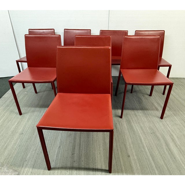 Design Plus Gallery presents a Set of Eight Oxblood Leather Side Chairs from Italy. The chairs are constructed with a...