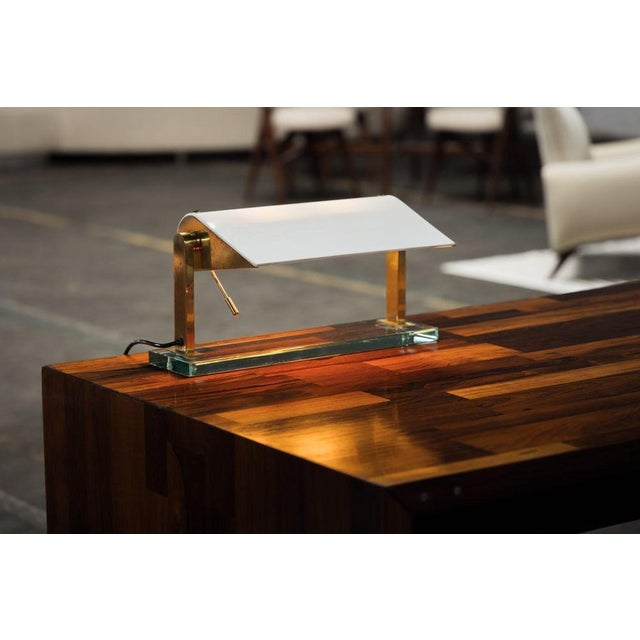 This rare table lamp, originally designed by the renowned italian designer pietro chiesa in 1939 and later manufactured by...