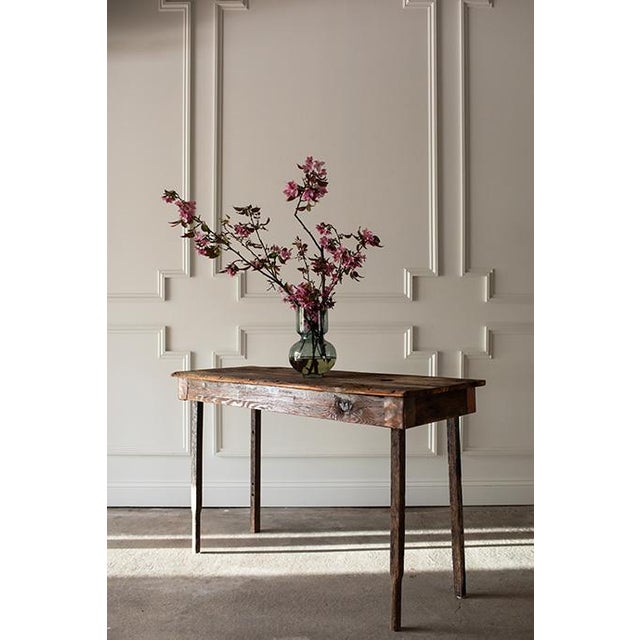 This exceptional late-19th-century primitive console table masterfully balances raw history with modern structural...
