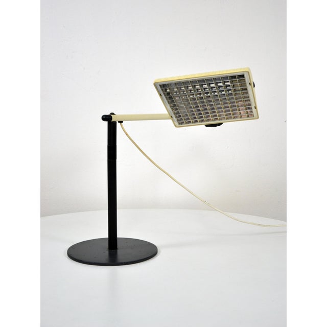 This adjustable desk lamp was produced by Waldmann Leuchten in the 1970s. It works with neon light bulbs and has a maximum...