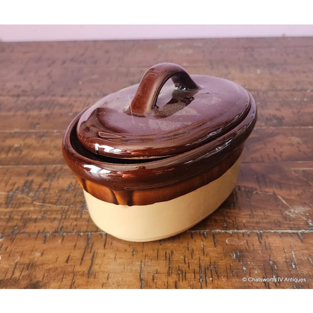 This is a great small sized brown toned stoneware lidded casserole or oval serving dish, unmarked, 1980s. Measures 6 X 4.5...