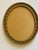 Vintage gold tone relief oval frame with glass or tray.