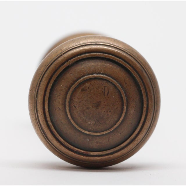 Concentric cast bronze doorknobs. The manufacturer and date of creation is unknown. Priced per pair of knobs with spindle....