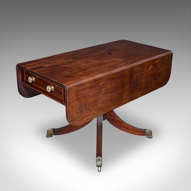 This is a large antique Pembroke table. An English, mahogany drop leaf dining table for four, dating to the Regency...
