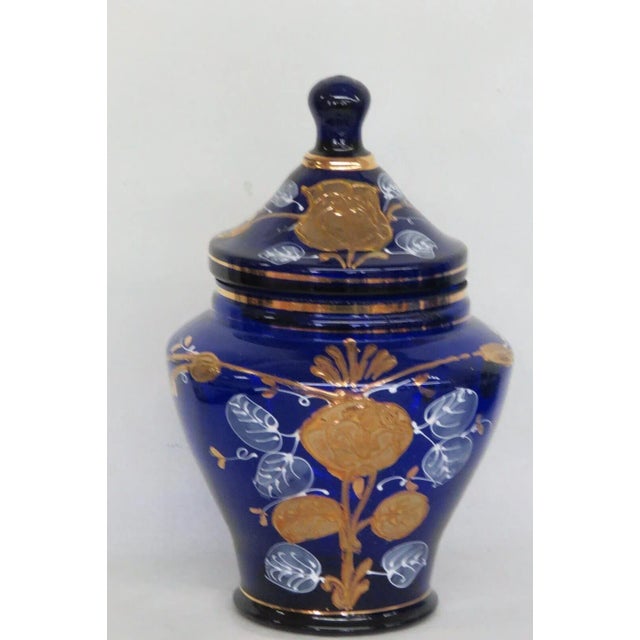 This beautiful Jar is made out of glass. This Jar has brilliant style; it features a gold hand painted design of roses to...