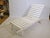 Triconfort's "Riviera" garden lounger on wheels features a wooden frame and a fabric reclining surface in a clean,...