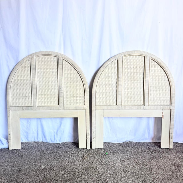 A charming pair of twin headboards crafted in classic boho chic style, featuring white washed wrapped wicker frames with...