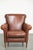This timeless armchair, made of sheepskin and featuring an English-style design, has a warm cognac color and a beautiful...
