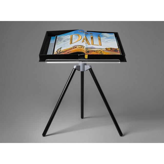 From the leading designer Marc Newson, this elegant tripod bookstand brings a new level of distinction to your TASCHEN...
