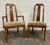 This is an elegant pair of vintage Mid Century Modern or Regency / Neoclassical style dining chairs featuring tall open...