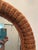 This is a vintage 1970s oval mirror with a woven rattan wicker frame. Stunning mid-century organic oval mirror completely...