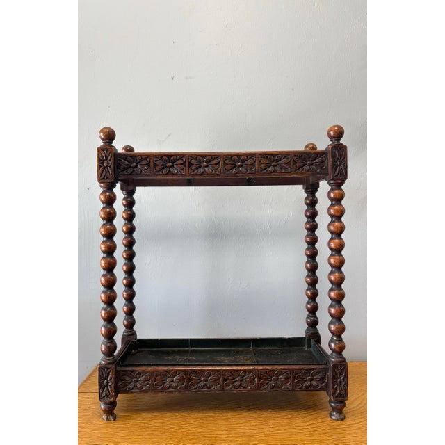 This antique English oak stick and umbrella stand is a masterclass in Victorian craftsmanship, where even the most...