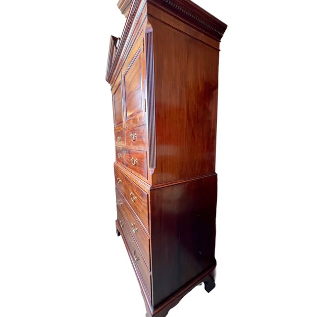 Early 19th Century American linen press butler's cabinet and desk crafted of mahogany and Chippendale-style. The top...