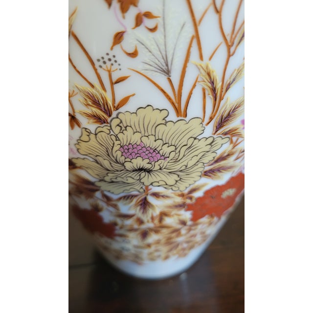 Elevate your space with this exquisite hand-painted ceramic vase, a celebration of delicate artistry and timeless charm....