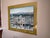 Large framed limited-edition print by French artist Michel Delacroix depicting a charming Parisian neighborhood filled...
