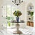 This vintage entry table is sure to be a focal point in any space. Featuring a hand carved solid mango Wood base with an...