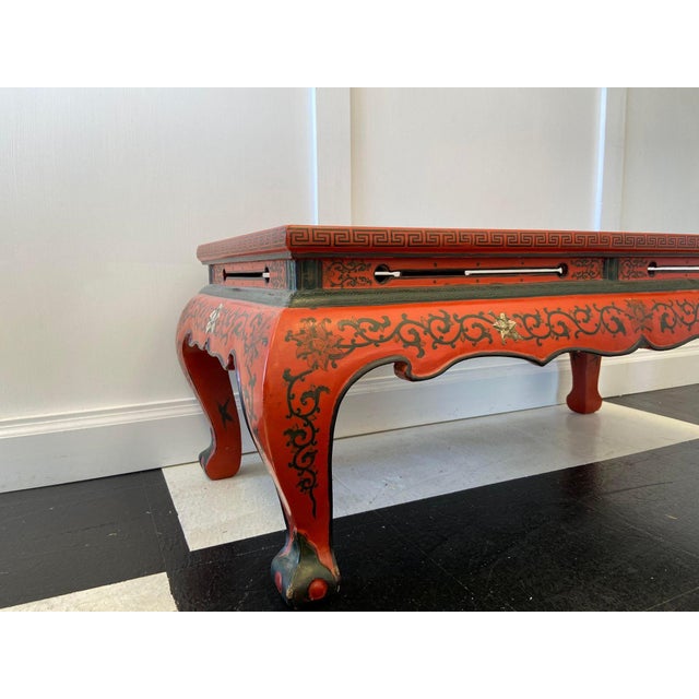 Beautiful hand painted red lacquer oriental cocktail table. This table has slight cracking on one leg. Paint is in very...