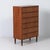 A Danish chest of drawers from the 1960s in warm teak, featuring a sleek Scandinavian mid-century design. The subtly...