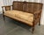 Elegant cane settee with wood frame in original walnut finish. The fully-upholstered base as well as upholstered seat...