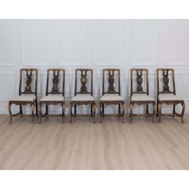 A striking set of six Swedish baroque chairs featuring dramatic carved frames and elegant proportions characteristic of...