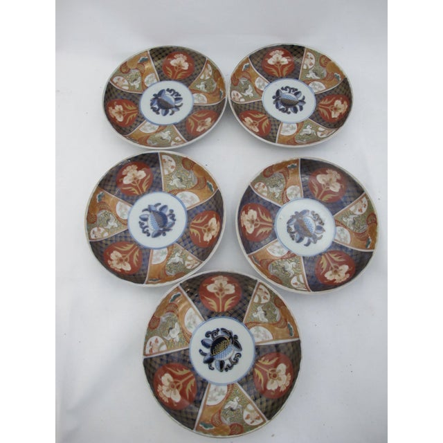 Japanese Imari heavy porcelain shallow bowl or plate set of 5. Features a radial design with panels alternating between...