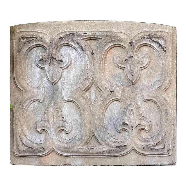 Collection of four antique ornamental cast stone architectural facade relief panels featuring raised, scrolled relief...