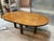 A truly exceptional and rare dining or conference table featuring a stunning exotic burl wood veneer top in a rich,...