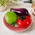 A vibrant vintage art glass fruit centerpiece featuring a richly colored tomato, textured lemon, and sculptural eggplant...