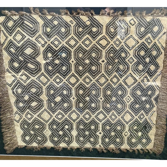 I've been told that this is a Congolese textile sample called Shoowa Kuba Raffia. Nicely woven with tan and black colors,...
