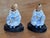Pair of Chinese nodders seated cross legged in white robes painted with blue floral sprigs and banding, their heads...