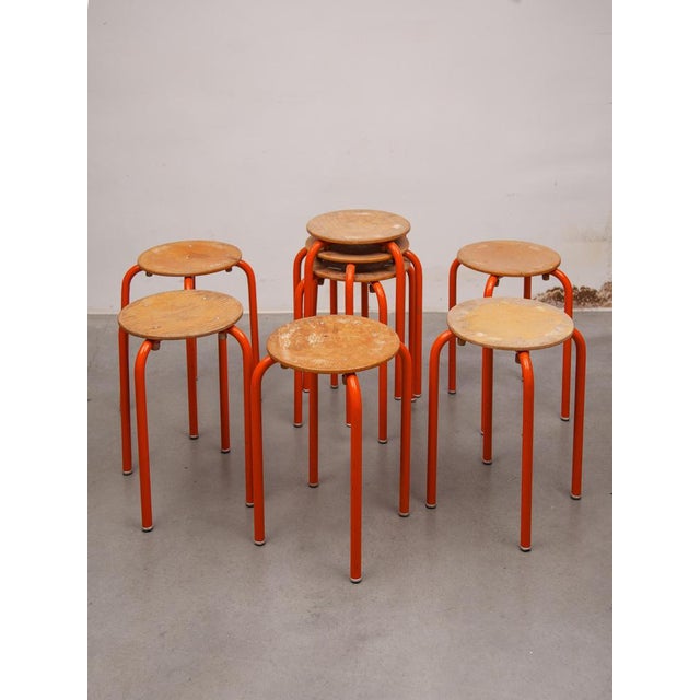 Set of 8 industrial Atelier stacking stools with metal tube legs and beech round seat.