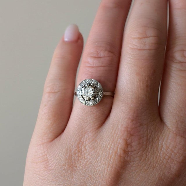 A refined Art Deco halo ring from circa 1930, precise, elegant, and entirely characteristic of the period's mastery of...