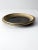 Vintage studio pottery plate, hand-crafted with a large, sculptural form. This ceramic plate features a richly layered...