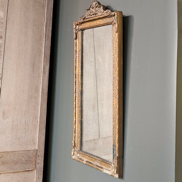 This exquisite rectangular giltwood mirror from 19th-century Italy is a timeless piece that exudes charm and...