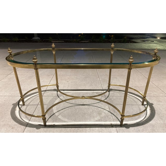 Neoclassical Jansen style brass and glass elliptical coffee table having large pinecone finials, manner of Maison Baguès,...